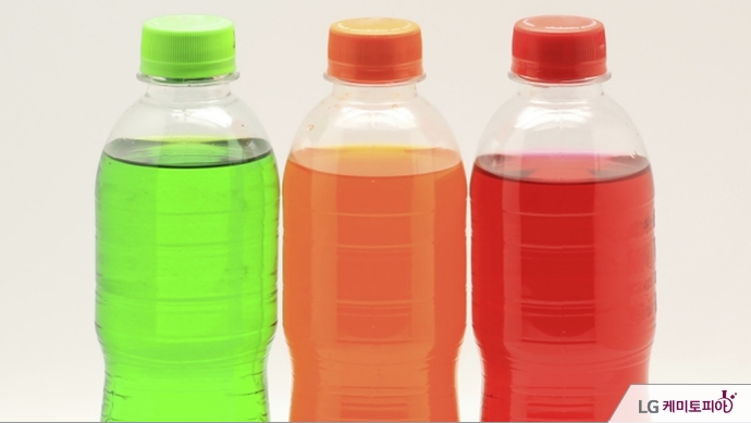 다양한 색깔의 음료들이 투명 플라스틱 병에 담겨 있다.