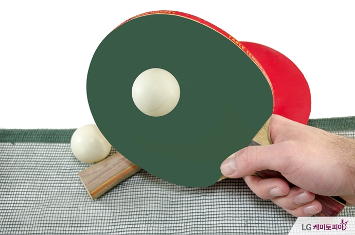 Male hand holding a ping pong racket, isolated